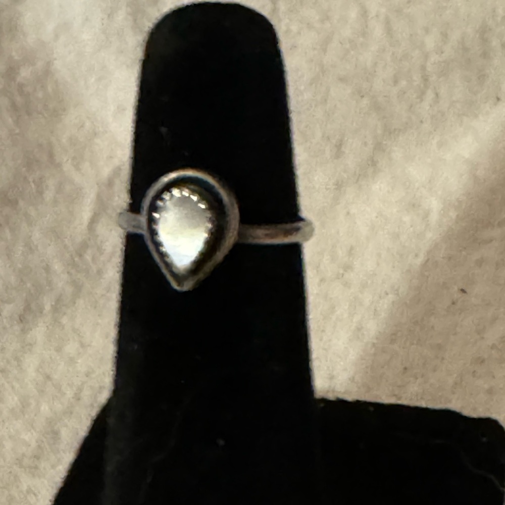 Delicate, sterling silver ring with Mother of Pearl center stone